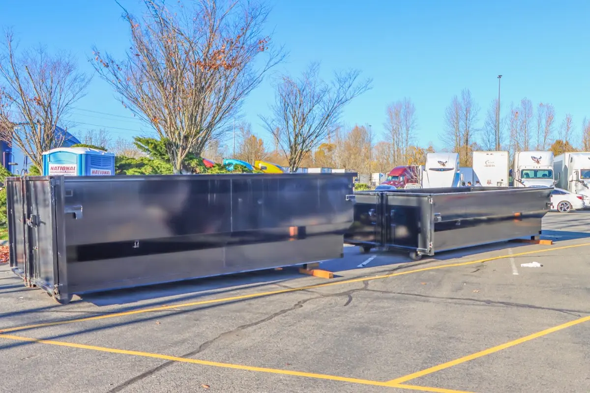 Professional dumpster rental service with roll-off container on residential driveway in Harwich
